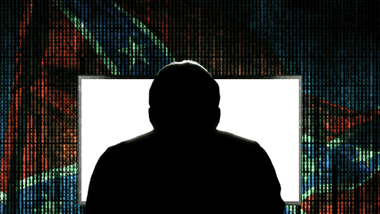 silhouette of a person at a computer